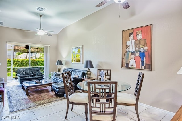 dining area with vaulted ceiling, visible vents, light tile patterned flooring, and a ceiling fan