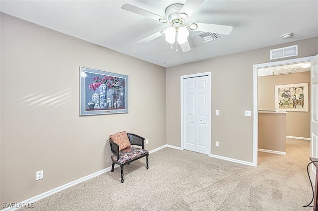 unfurnished room with ceiling fan, light carpet, and visible vents