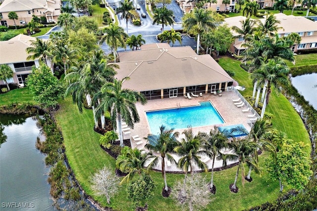 pool with a patio, a water view, and a residential view