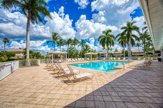 pool with a patio, fence, and a gazebo