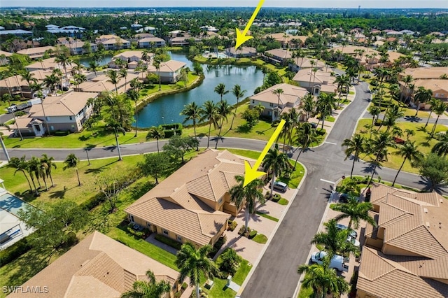 birds eye view of property with a water view and a residential view