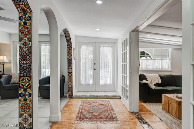 entryway featuring french doors, arched walkways, a wealth of natural light, and recessed lighting