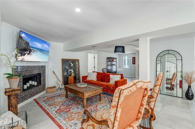 living room featuring visible vents, recessed lighting, and a tile fireplace