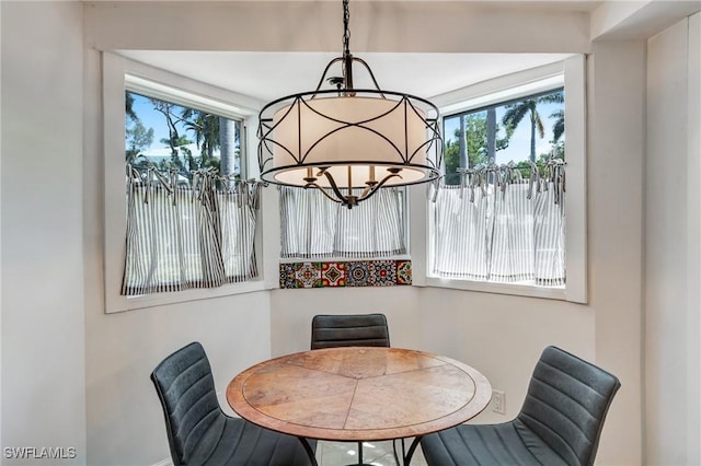 dining area with a notable chandelier and a wealth of natural light