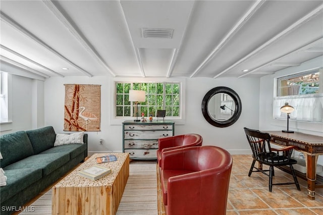 living room featuring light tile patterned floors, baseboards, visible vents, and beam ceiling