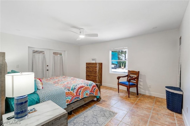 bedroom with a ceiling fan, baseboards, and light tile patterned floors