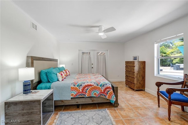 bedroom with ceiling fan, baseboards, visible vents, and light tile patterned floors