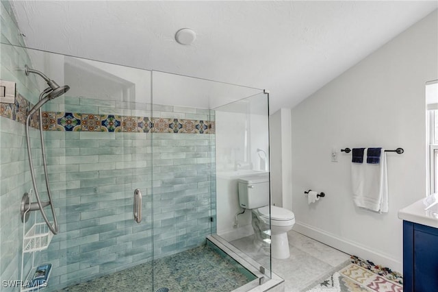 full bathroom with vaulted ceiling, a shower stall, baseboards, vanity, and toilet