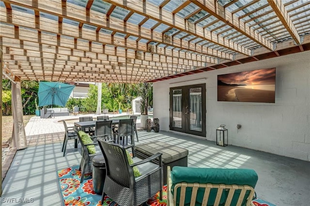 view of patio / terrace with french doors, outdoor dining space, and a pergola