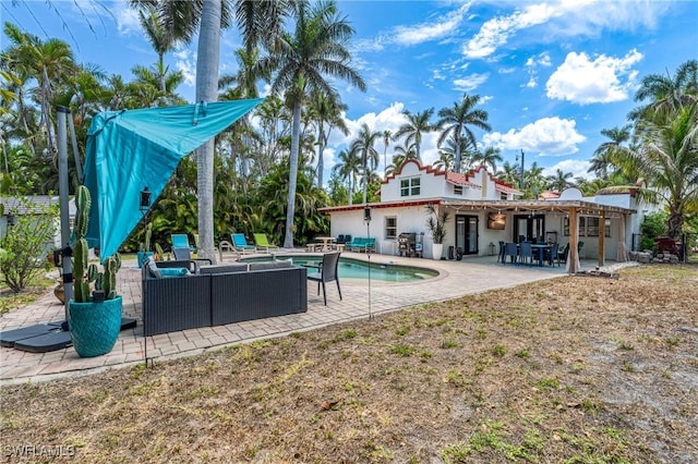 outdoor pool with an outdoor hangout area and a patio area