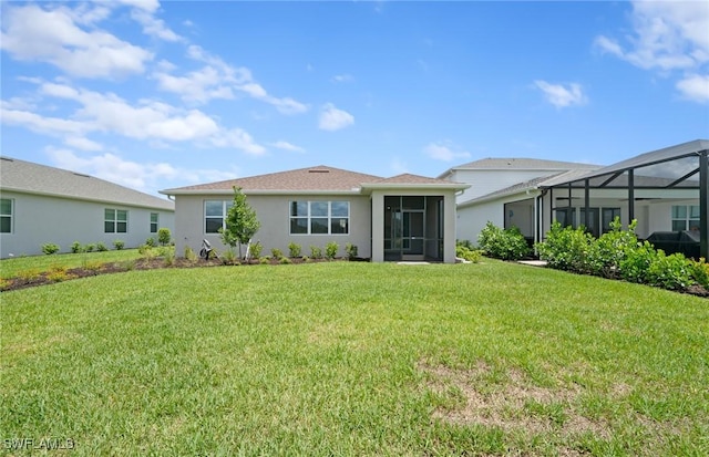 42729 Valley Brooks St, Punta Gorda, FL 33982 - rear view of house featuring a yard, stucco siding, and glass enclosure