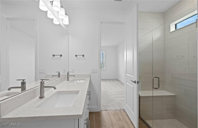 42729 Valley Brooks St, Punta Gorda, FL 33982 - full bath with double vanity, a stall shower, and wood finished floors
