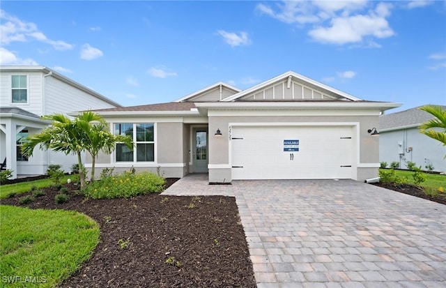 42729 Valley Brooks St, Punta Gorda, FL 33982 - view of front of house with decorative driveway, stucco siding, and an attached garage