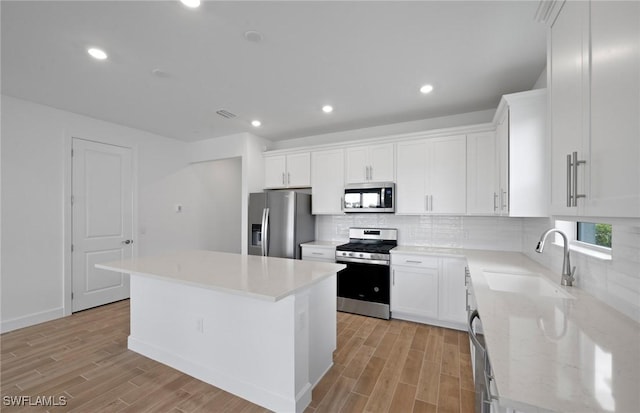 42729 Valley Brooks St, Punta Gorda, FL 33982 - kitchen featuring stainless steel appliances, light wood-type flooring, backsplash, and recessed lighting