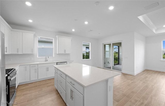 42729 Valley Brooks St, Punta Gorda, FL 33982 - kitchen with appliances with stainless steel finishes, light wood finished floors, recessed lighting, healthy amount of natural light, and light countertops