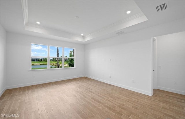 42729 Valley Brooks St, Punta Gorda, FL 33982 - spare room with a raised ceiling, ornamental molding, light wood-style flooring, and recessed lighting