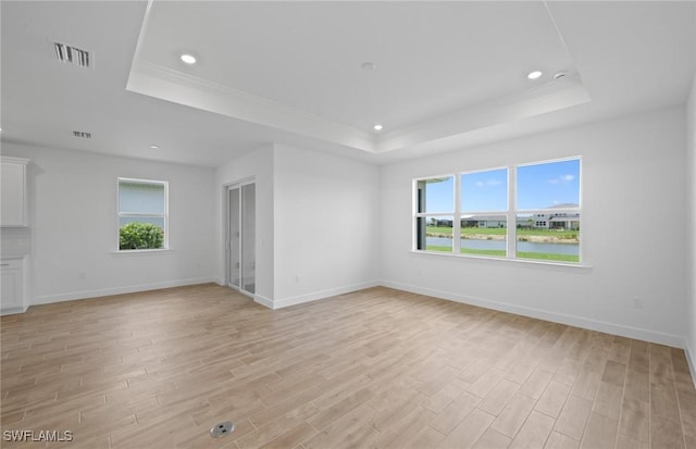 42729 Valley Brooks St, Punta Gorda, FL 33982 - spare room featuring a tray ceiling, healthy amount of natural light, light wood finished floors, recessed lighting, and crown molding