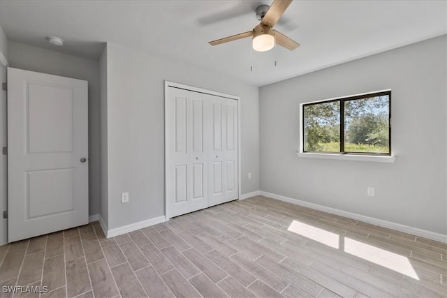 2609 59th St W, Lehigh Acres, FL 33971 - unfurnished bedroom with a closet, wood finished floors, baseboards, and ceiling fan