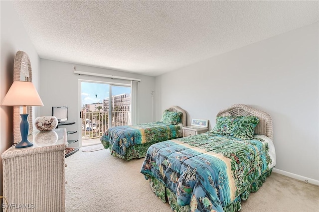 carpeted bedroom featuring a textured ceiling and access to outside
