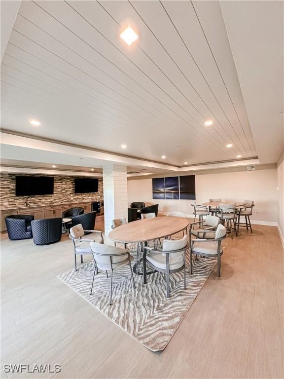 dining area featuring baseboards, recessed lighting, and wood finished floors