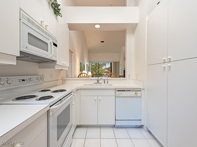 1036 Egrets Walk Cir Unit 202, Naples, FL 34108 - kitchen featuring white cabinets, a sink, white appliances, light countertops, and light tile patterned floors