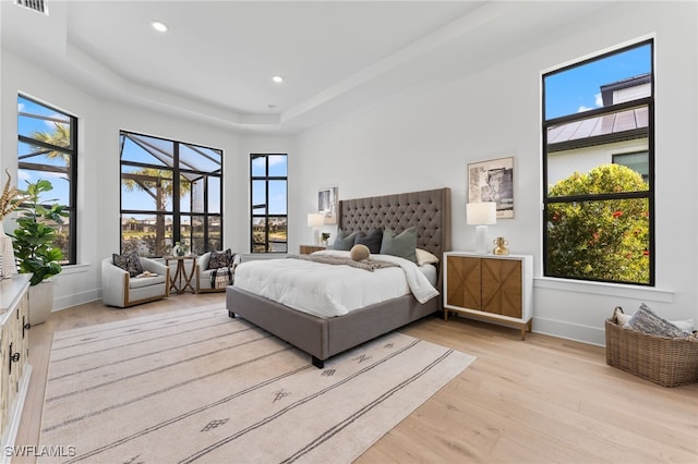 16214 Verilyn Cir, Naples, FL 34110 - bedroom featuring light wood-type flooring, a raised ceiling, baseboards, visible vents, and recessed lighting