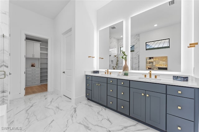 16214 Verilyn Cir, Naples, FL 34110 - bathroom with a spacious closet, marble finish floor, visible vents, a marble finish shower, and a sink