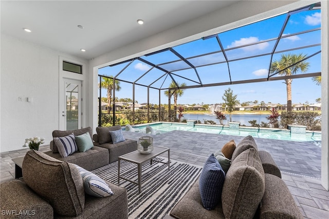 16214 Verilyn Cir, Naples, FL 34110 - view of patio with a lanai, an outdoor pool, an outdoor hangout area, and a water view