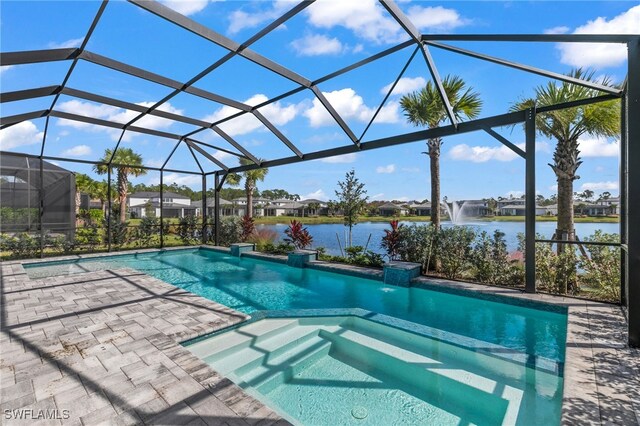 16214 Verilyn Cir, Naples, FL 34110 - view of swimming pool with a residential view, glass enclosure, a pool with connected hot tub, and a water view