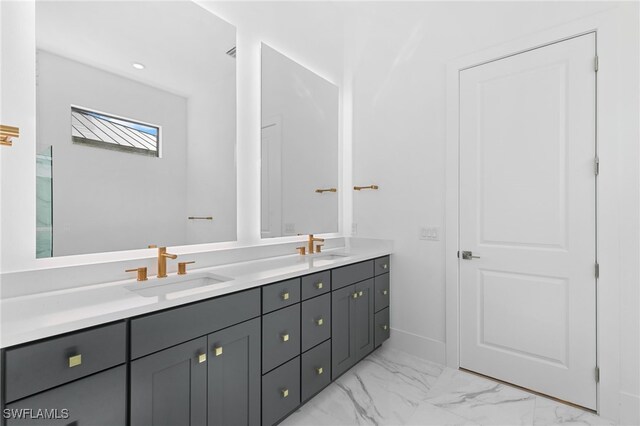 16214 Verilyn Cir, Naples, FL 34110 - bathroom featuring double vanity, marble finish floor, baseboards, and a sink