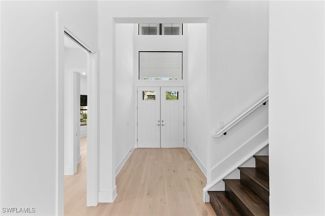 16214 Verilyn Cir, Naples, FL 34110 - foyer entrance with baseboards, light wood-type flooring, a high ceiling, and stairs