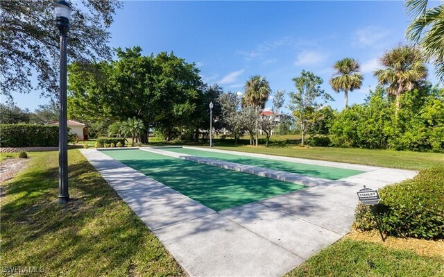 view of sport court featuring a yard