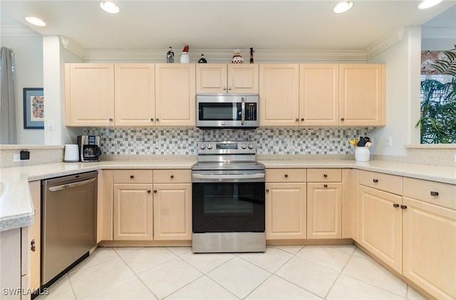 kitchen with light brown cabinetry, appliances with stainless steel finishes, and ornamental molding