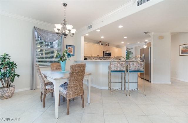 dining area featuring an inviting chandelier, ornamental molding, and visible vents