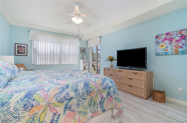bedroom with baseboards, ornamental molding, ceiling fan, and light wood-style floors