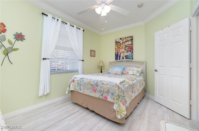 bedroom featuring baseboards, ornamental molding, light wood finished floors, and ceiling fan