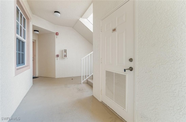additional living space with a textured wall and stairs