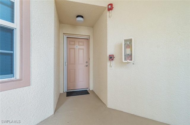 view of exterior entry featuring stucco siding