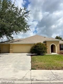 18301 Pine Nut Ct, Lehigh Acres, FL 33972 - single story home featuring concrete driveway, stucco siding, a front lawn, and a garage