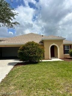 18301 Pine Nut Ct, Lehigh Acres, FL 33972 - single story home featuring concrete driveway, stucco siding, and a front lawn