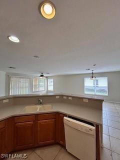 18301 Pine Nut Ct, Lehigh Acres, FL 33972 - kitchen featuring brown cabinetry, a ceiling fan, dishwasher, light tile patterned floors, and a sink