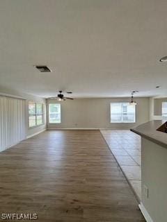 18301 Pine Nut Ct, Lehigh Acres, FL 33972 - interior space featuring baseboards, ceiling fan, wood finished floors, and visible vents