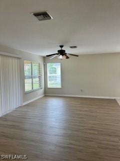 18301 Pine Nut Ct, Lehigh Acres, FL 33972 - spare room featuring baseboards, ceiling fan, wood finished floors, and visible vents