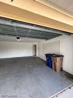 18301 Pine Nut Ct, Lehigh Acres, FL 33972 - garage featuring a garage door opener