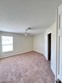 18301 Pine Nut Ct, Lehigh Acres, FL 33972 - spare room with carpet floors, a ceiling fan, and baseboards