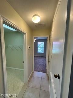 18301 Pine Nut Ct, Lehigh Acres, FL 33972 - corridor featuring light tile patterned flooring and baseboards