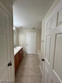 18301 Pine Nut Ct, Lehigh Acres, FL 33972 - bathroom featuring toilet, a shower, tile patterned flooring, and vanity