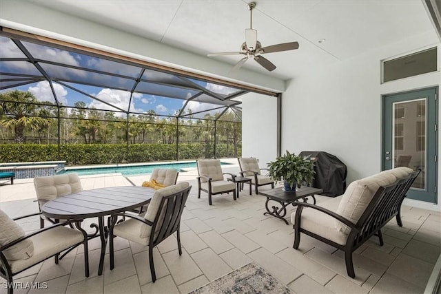view of patio featuring grilling area, a pool with connected hot tub, glass enclosure, and ceiling fan