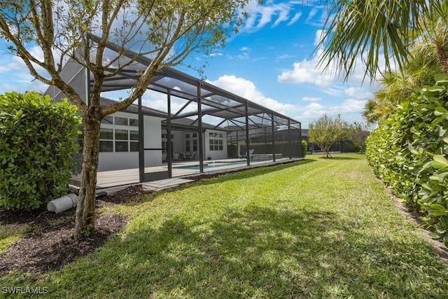view of yard featuring glass enclosure and an outdoor pool