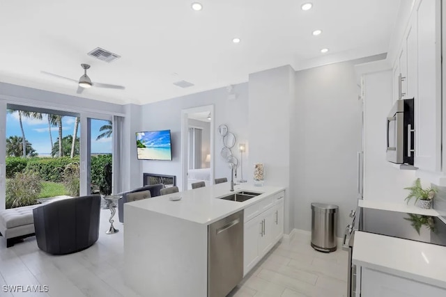 140 Seaview Ct Unit 103N, Marco Island, FL 34145 - kitchen featuring open floor plan, a sink, a peninsula, and stainless steel appliances